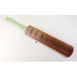 A 1950's miniature souvenir cricket bat with the players signatures