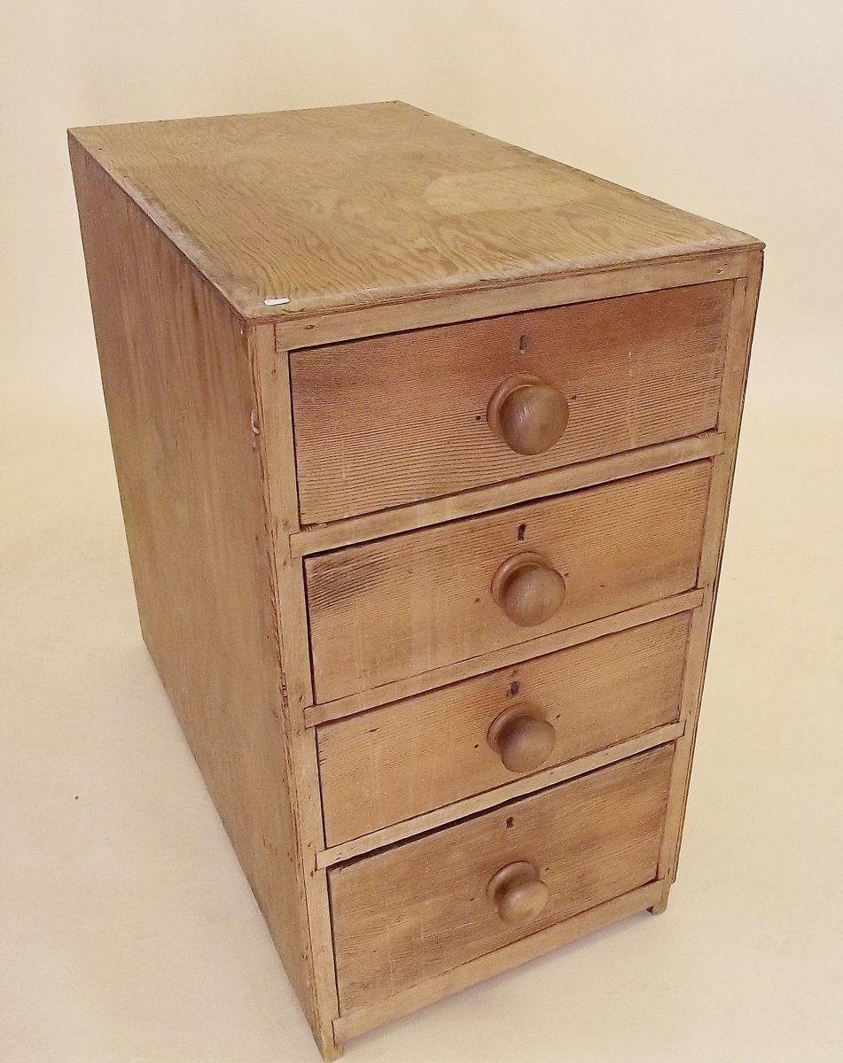 An early 20th century pine filing cabinet with four drawers