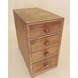 An early 20th century pine filing cabinet with four drawers