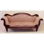 An early Victorian mahogany framed settee with scroll over arms and turned supports