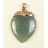 A jade heart form pendant on 14 carat gold floral mount