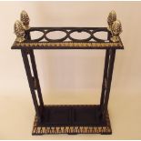 A modern brass and 'cast iron' stick stand with acorn finials