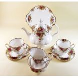 A Royal Albert Country Roses tea service comprising: teapot, six cups and saucers, six tea plates,