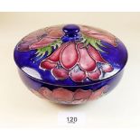 A Moorcroft bowl and cover painted anemone on a blue ground - 17cm dia