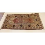 A pink ground Turkoman style rug with geometric decoration - 191 x 104cm