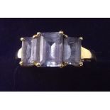 A 14 cart gold three stone amethyst ring - size N