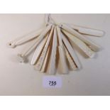 A set of carved bone miniature tools