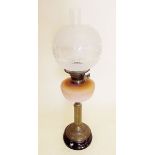 A Victorian oil lamp with peach glass reservoir and etched shade