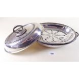 A silver plated entree dish with liners