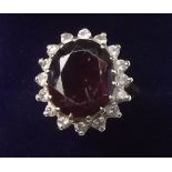 An 18 carat gold diamond and garnet cluster ring - size N