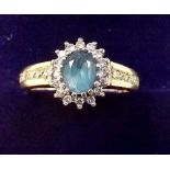 A 9 carat gold diamond and blue topaz ring, size K