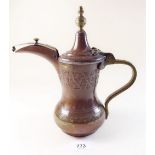 A Turkish copper and brass coffee pot