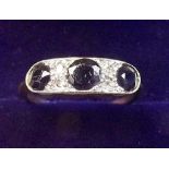 A gold ring set three sapphires and chip diamonds - unmarked