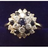 A 9 carat gold sapphire and white stone ring