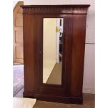An Edwardian mahogany and satinwood strung wardrobe with pendant carved cornice over single mirror