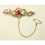 An Edwardian 9 carat gold brooch set seed pearls and red stone