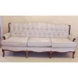 A mahogany framed three seater cream button upholstered settee