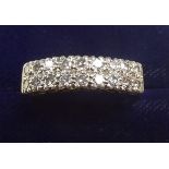 An 18 carat white and yellow gold ring set two rows of eight diamonds - overall diamond weight