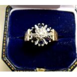 A 9 carat gold diamond and sapphire cluster ring with engraved shoulders, size P