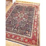 A large Persian style floral rug on blue ground with deep red borders - 254 x 345cm