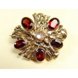 A 9 carat gold brooch set garnets and moonstone