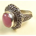 A silver ring set pink jade