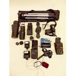 A group of cameras and equipment including tripod, lenses, light meter etc