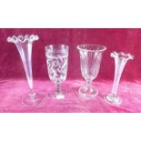 A group of four large glass vases including a celery vase - 25cm high