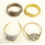 A 22 carat gold wedding band, a three stone diamond ring a/f, a silver snake ring etc