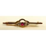 An early 20th century bar brooch with seed pearls and red stone - boxed