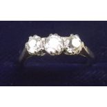 An 18ct white gold or platinum three stone diamond ring, size M