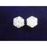 A pair of rhodium plated 9 carat gold diamond cluster earrings (with silver backs)