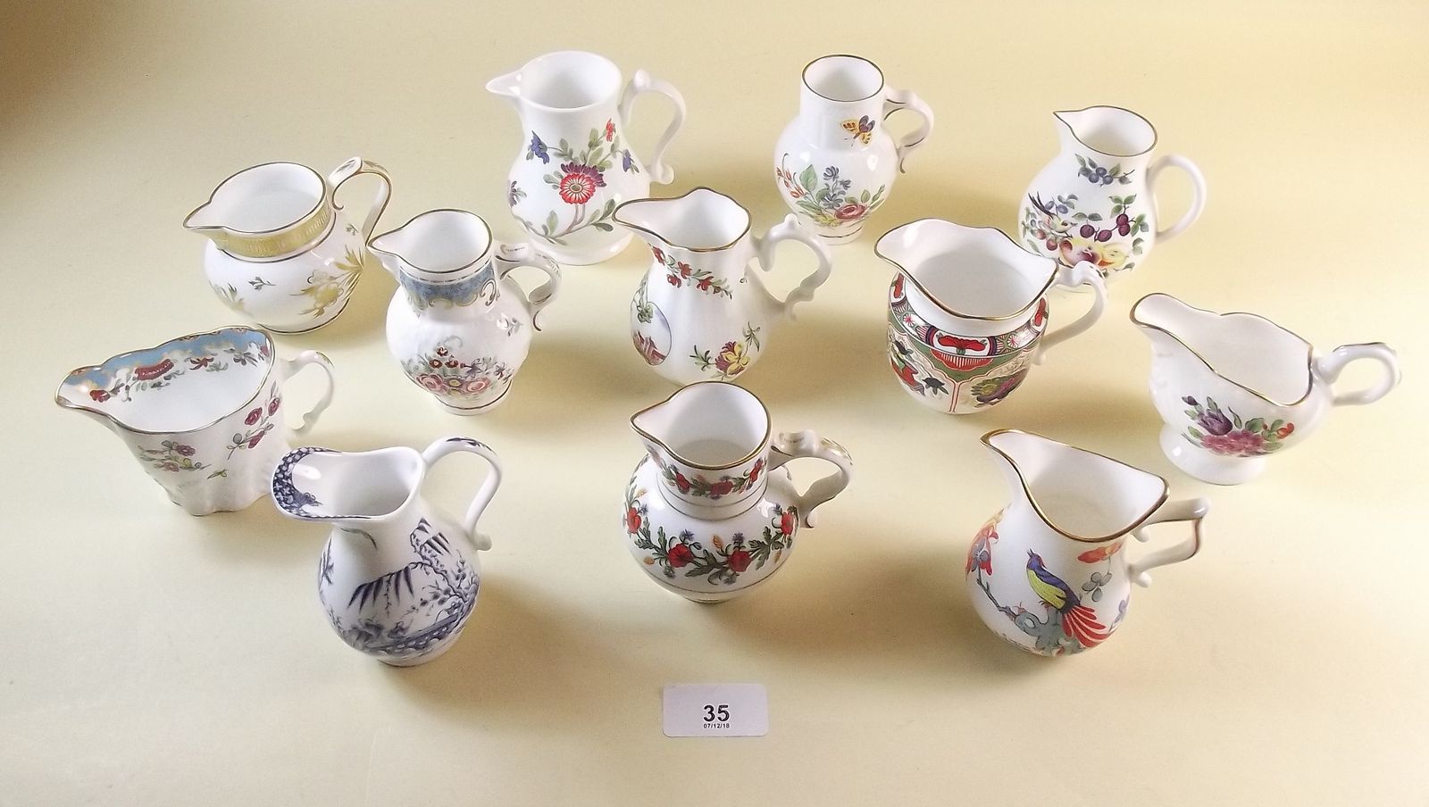 A set of twelve Compton and Woodhouse reproduction Worcester jugs