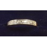 An 18 carat gold half eternity ring set nine chip diamonds, size N