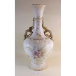 A large Edwardian vase painted flowers on an ivory blush ground with gilt scrollwork handles -