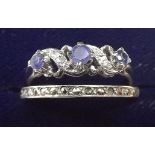 A silver eternity ring and a white metal ring set tanzanites