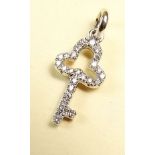 An 18 carat gold diamond set miniature key