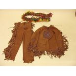 A mid 20th century Native American buck skin jacket and trousers with feathered headdress