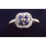 An 18 carat white sapphire and diamond ring - size L