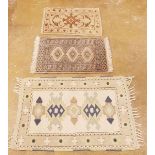 Three various small rugs - the largest measuring 82 x 125cm, medium measuring 59 x 92cm and smallest