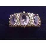 As 9 carat gold three stone amethyst ring, size O