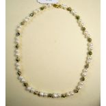 A freshwater pearl necklace with green enamel and filigree beads