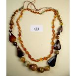 An amber necklace and a heavy antique facet cut necklace