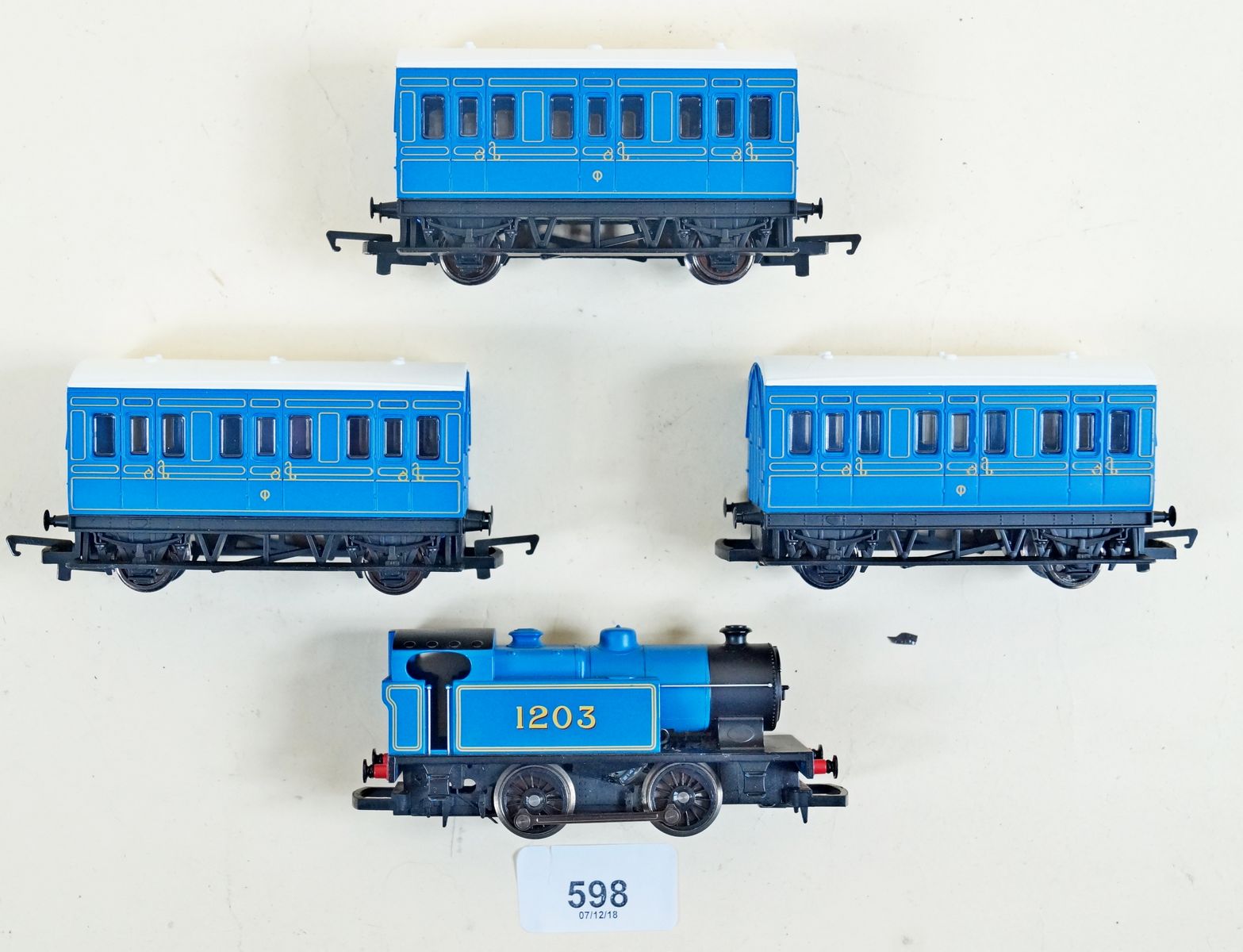 A Hornby 1203 00HO 0 - 4 - 0 tank locomotive blue livery, three coach Caledonian set