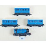 A Hornby 1203 00HO 0 - 4 - 0 tank locomotive blue livery, three coach Caledonian set