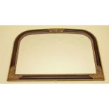 A reproduction black and gold framed overmantel mirror