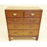 An early 19th century mahogany chest of two short and three long drawers with some replacement brass