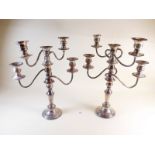 A pair of silver plate on copper five branch candleabrum