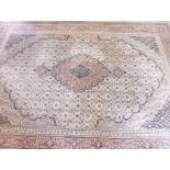 A large Persian style carpet with medallion design on cream ground - 339 x 251cm