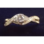 An 18 carat gold ring set three diamonds on interlaced diamond set band, size O -P